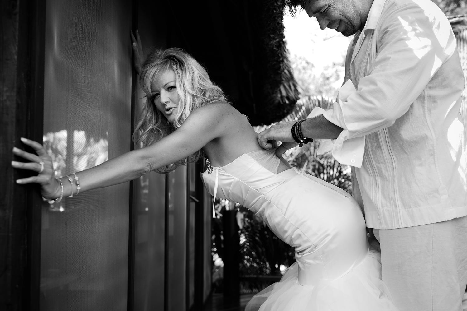 Trashing the dress off a waterfall in Belize.  Image by Belize wedding photographers, Leonardo Melendez Photography.